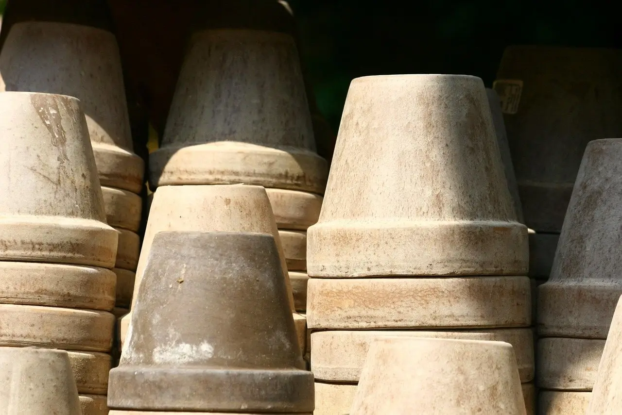 Stacks of weathered empty terracotta flower pots