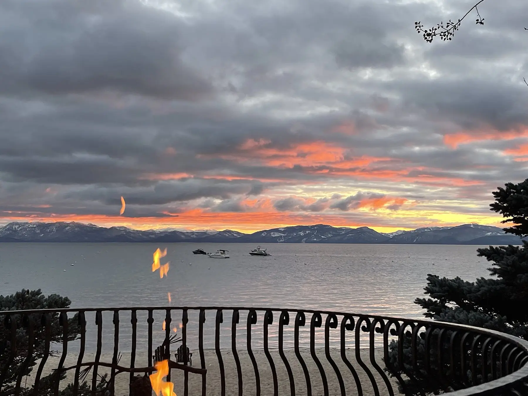 Gas flames burning along a railed terrace at sunset