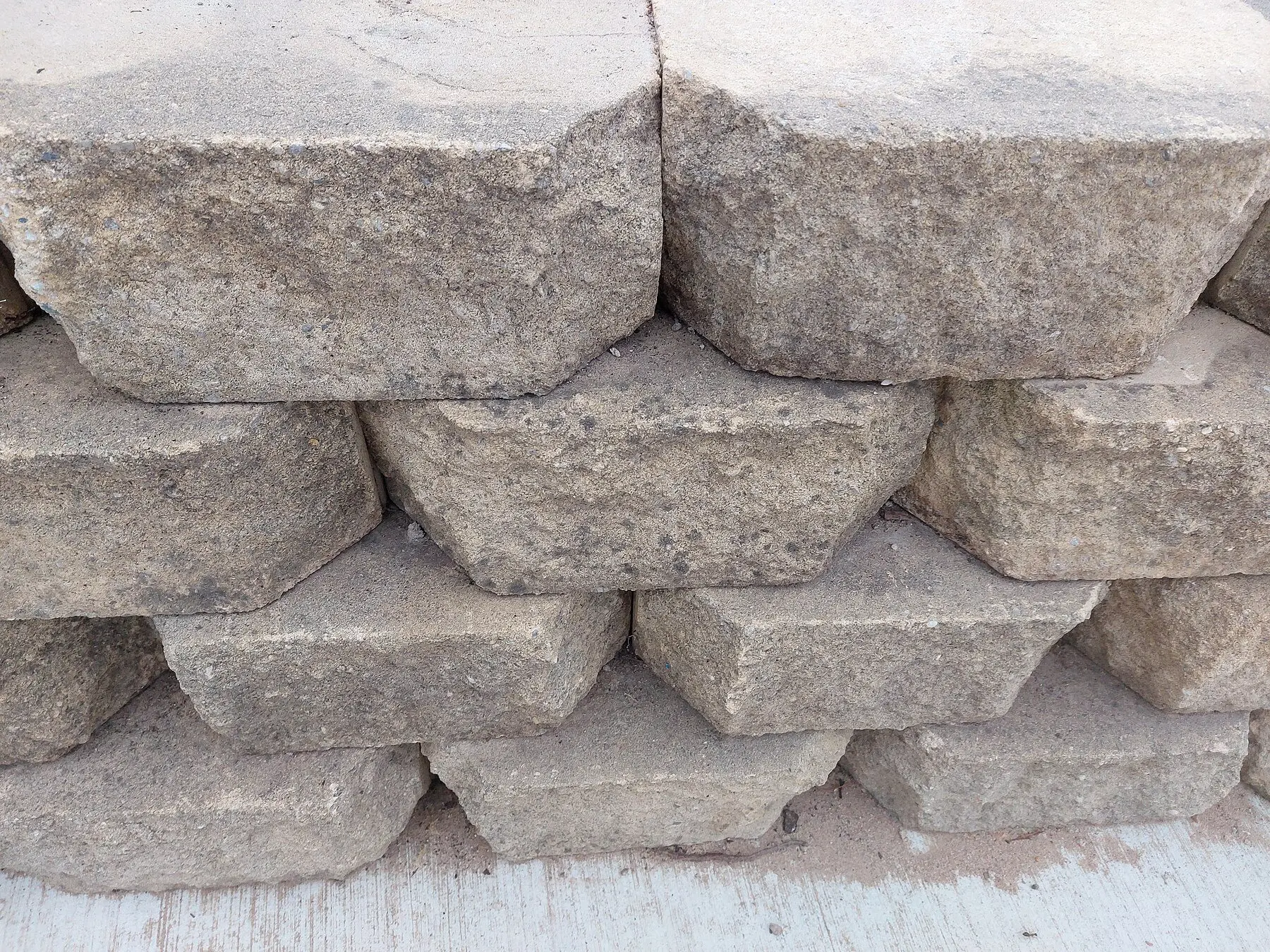 Segmental concrete retaining wall blocks stacked with a visible setback