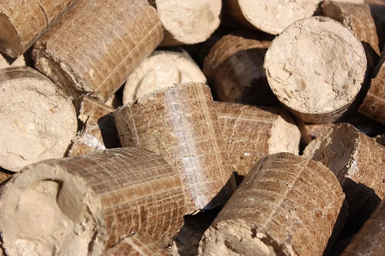 A close view of compressed wood fuel briquettes stacked together