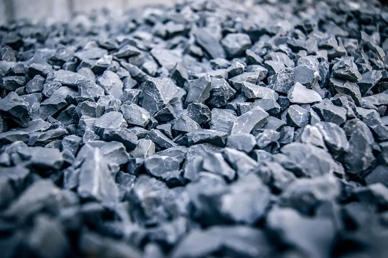 A close view of angular grey crushed stone spread as a ground covering