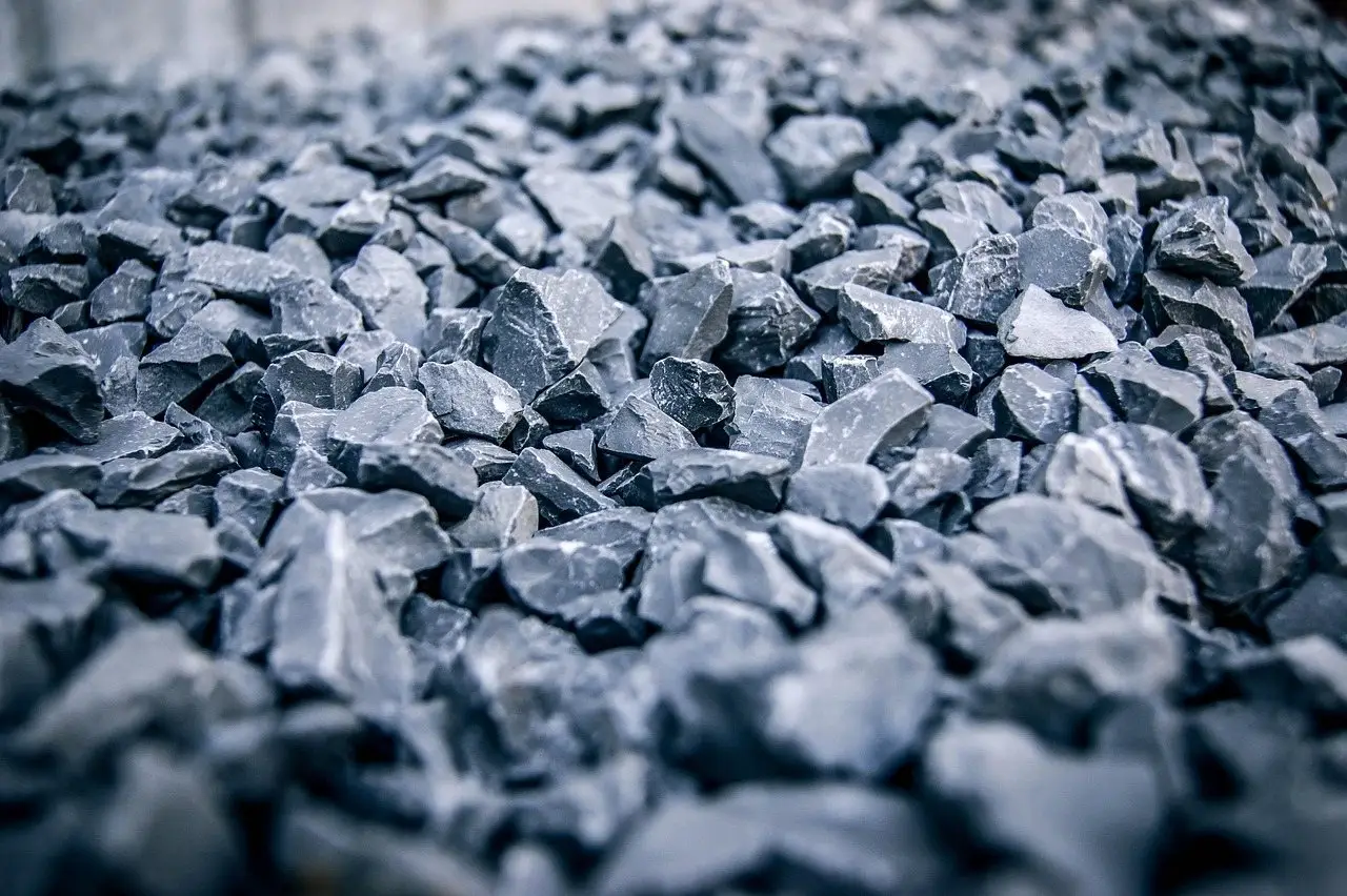 A close view of angular grey crushed stone spread as a ground covering