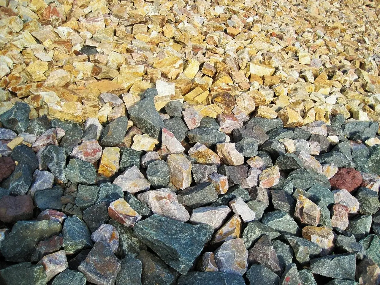 A heap of mixed grey and buff crushed stone and gravel