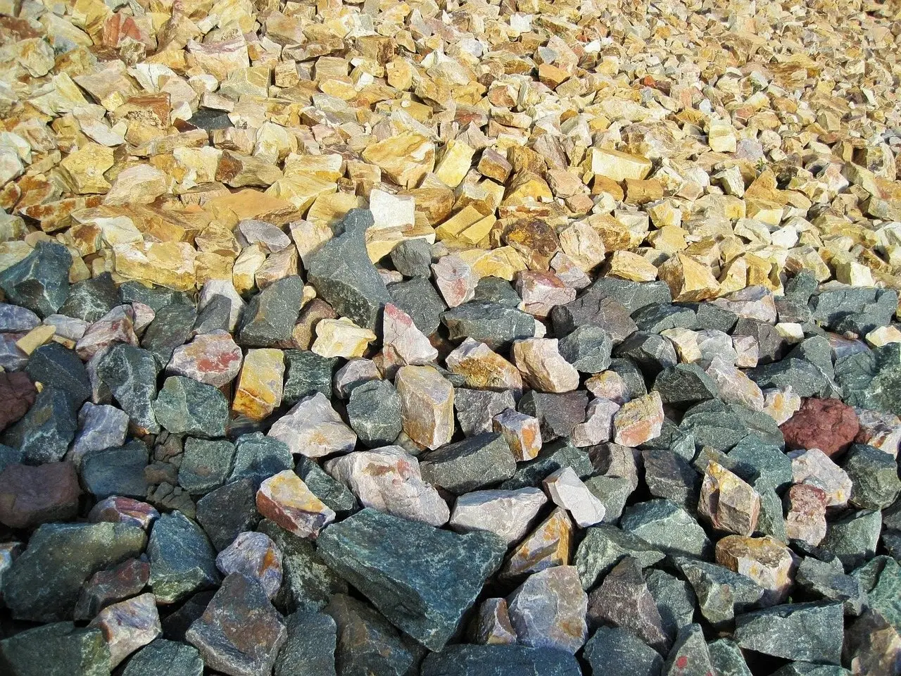 A heap of mixed grey and buff crushed stone and gravel